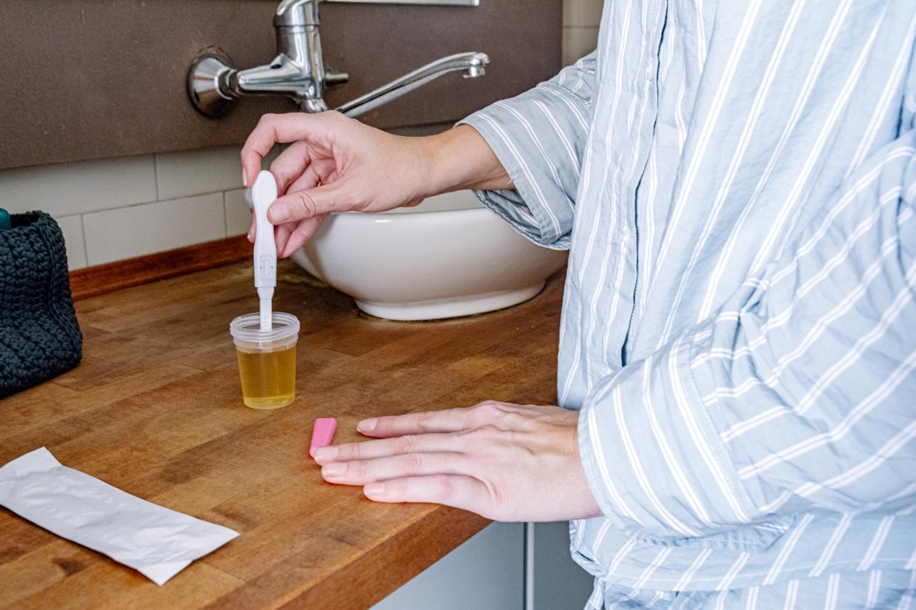 Woman making pregnancy test discovering positive results